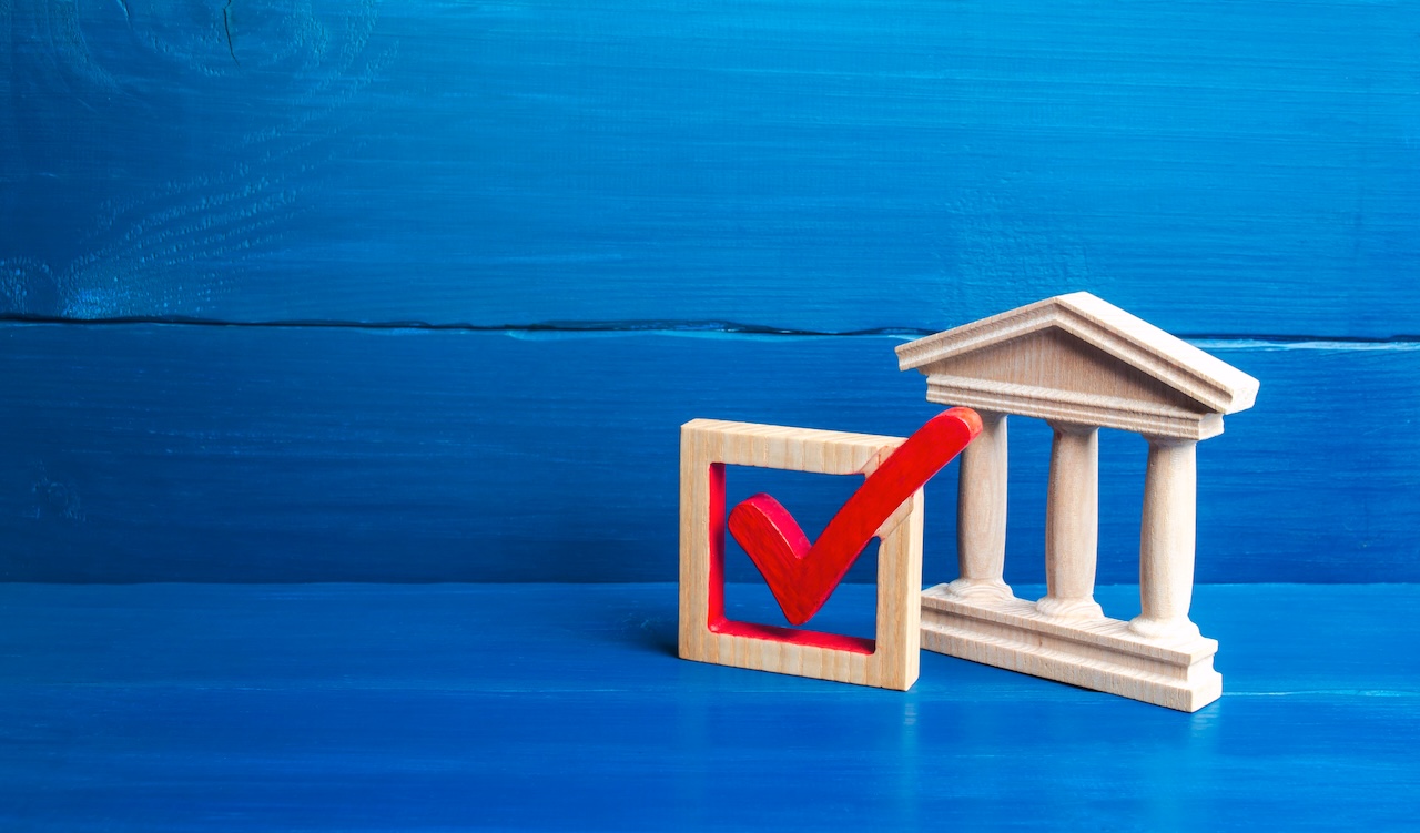 government building and red compliance check mark
