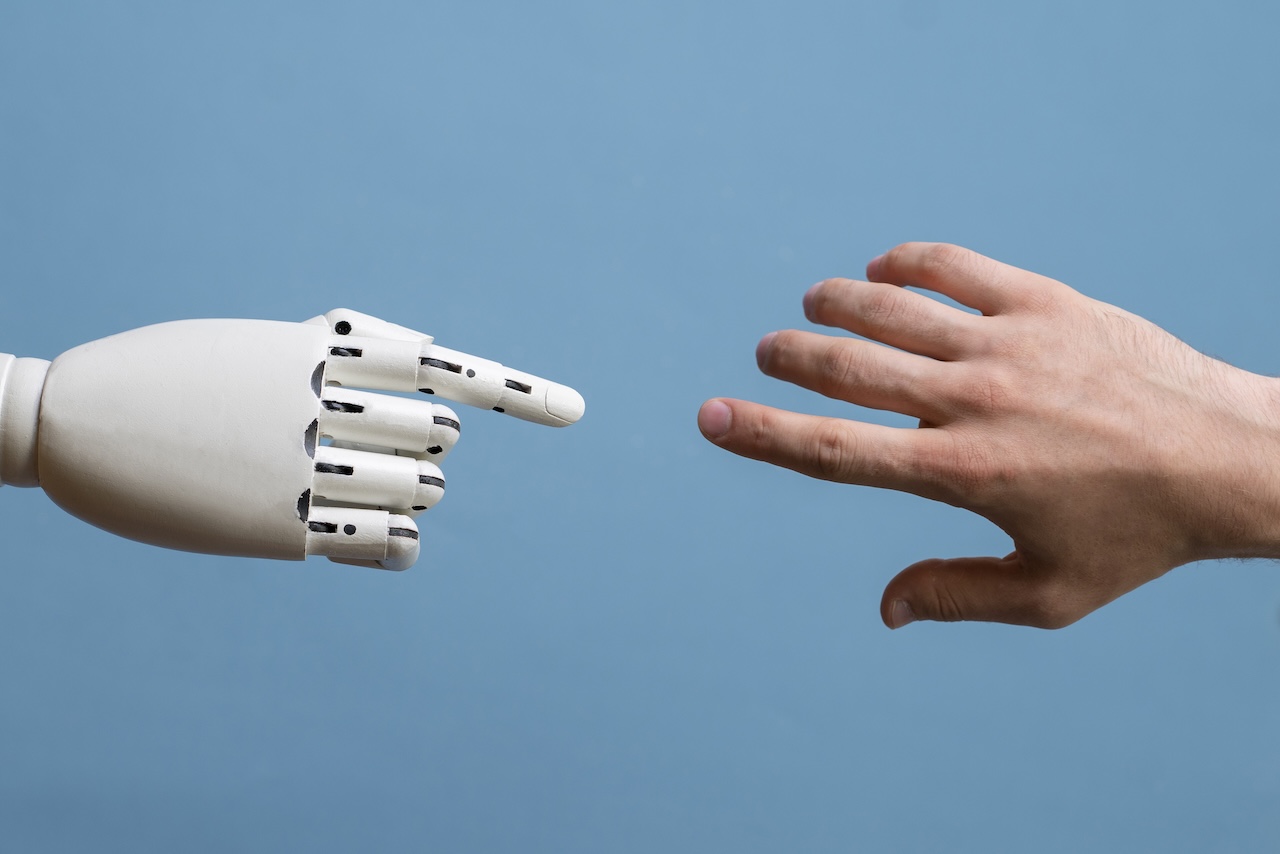 human vs ai robot hands reaching out